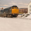 Winter Train Passing Overtoun Hotel.png
